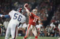 File-This Dec. 1, 1986, file photo shows San Francisco 49ers quarterback Joe Montana (16), passing before New York Giants linebacker Lawrence Taylor (56), can reach him during the first quarter of their NFL game in Candlestick Park, San Francisco. Members of a special panel of 26 selected all of them for the position as part of the NFL's celebration of its 100th season. All won league titles except Marino. All are in the Hall of Fame except Brady and Manning, who are not yet eligible. On Friday, Dec. 27, 2019, quarterback was the final position revealed for the All-Time Team. (AP Photo/Paul Sakuma, File)