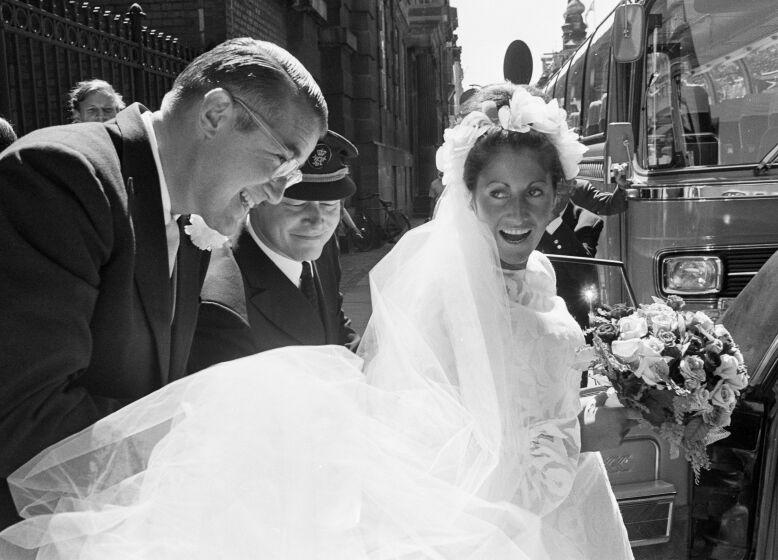 Dodgers president Peter O'Malley helps his bride, Annette Zacho, into a car following their wedding in 1971