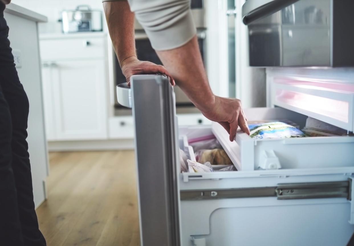 Person opening freezer drawer