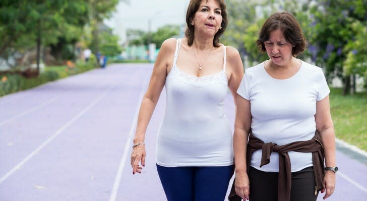 Two retirees walking in a park in Medellin, Colombia
