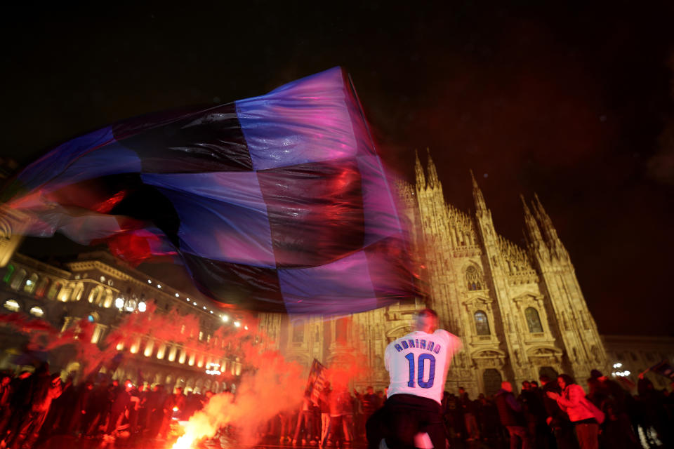 Inter Milan fans celebrate in Piazza Duomo square in front of the gothic cathedral after Inter Milan won the Serie A title against AC Milan in Milan, Italy, Monday, April 22, 2024. (AP Photo/Antonio Calanni)