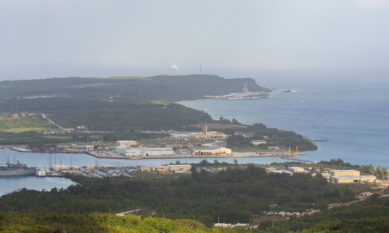 The aircraft carrier Theodore Roosevelt (upper right) is docked at Naval Base Guam in Apra Harbor on April 27, 2020. Guam has been under U.S. control since 1898. (Photo: TONY AZIOS/AFP via Getty Images)