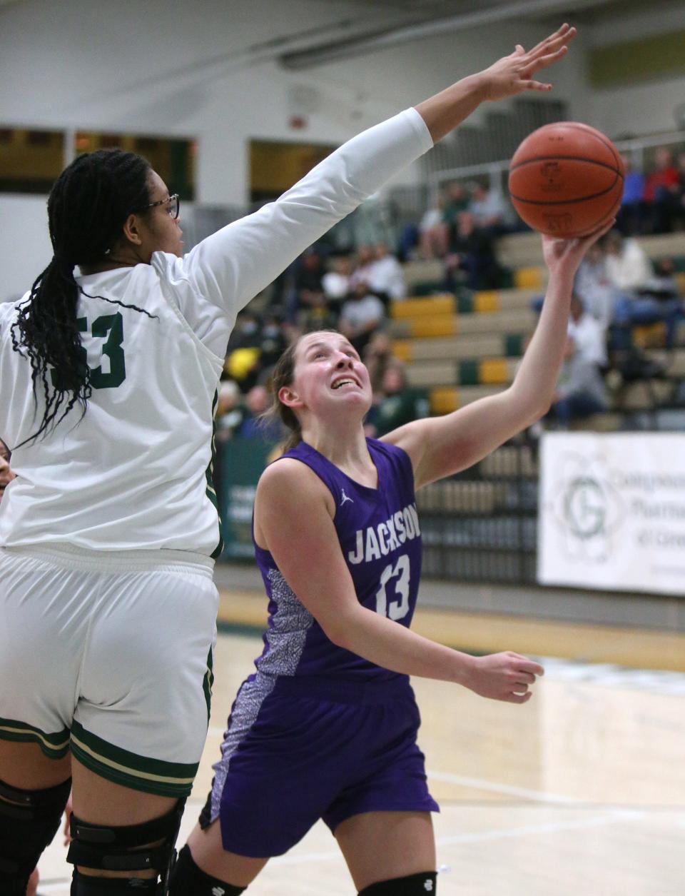 Jackson's Emma Dretke (13) takes a shot while being guarded by GlenOak's Jordan Weir (53) during their game at GlenOak on Wednesday.