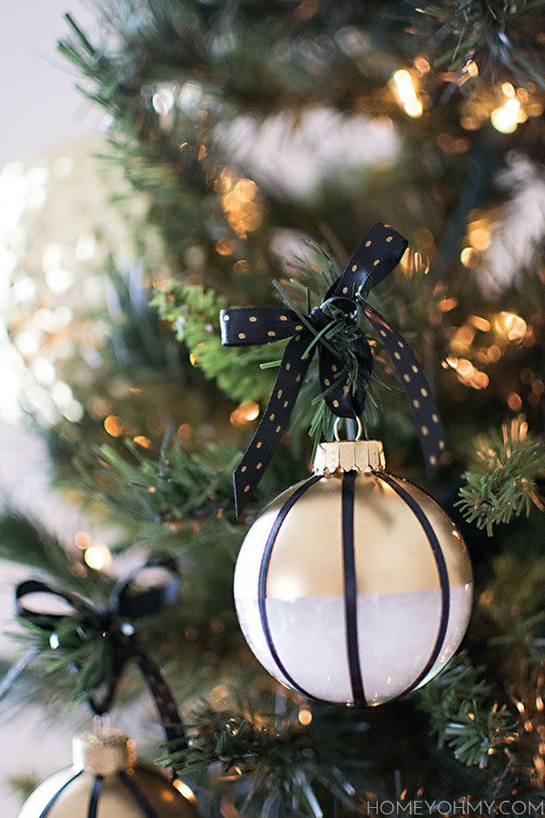 <p>Stripes will never go out of style—especially when they're black, and paired with gold and white. </p><p>Get the tutorial at <a href="http://www.homeyohmy.com/diy-black-white-gold-ornaments/" rel="nofollow noopener" target="_blank" data-ylk="slk:Homey Oh My!;elm:context_link;itc:0;sec:content-canvas" class="link ">Homey Oh My!</a>.</p>