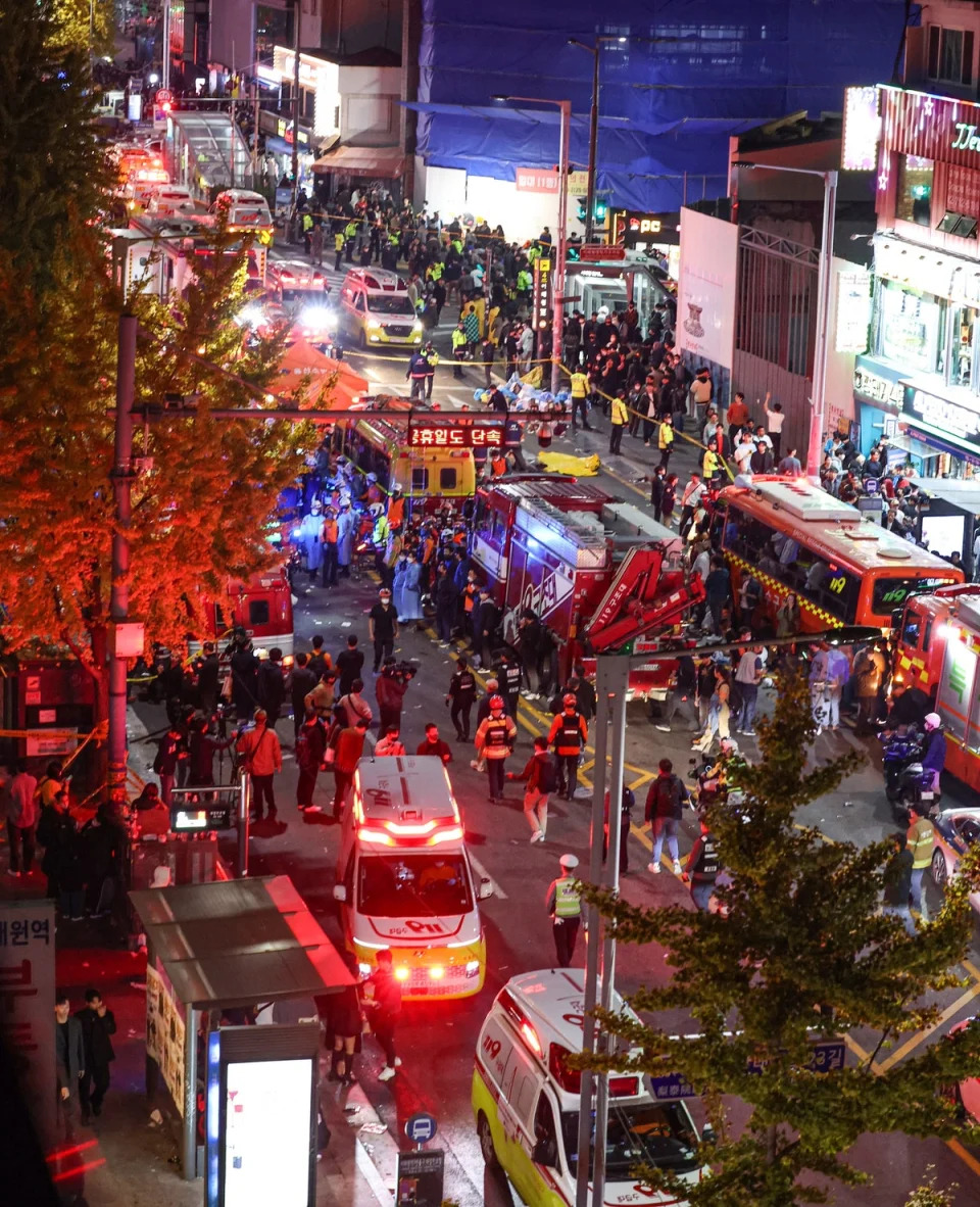 Emergency services at the scene following the crush in Seoul’s Itaewon district (EPA)