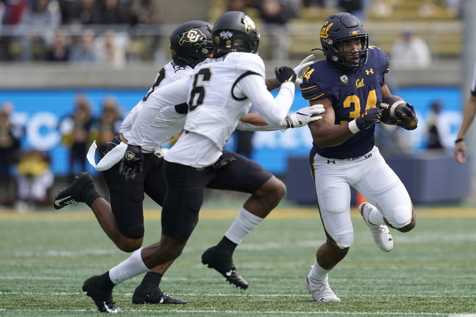 California running back Christopher Brooks (34) runs against Colorado cornerbacks Christian Gonzalez, left, and Mekhi Blackmon (6) during the second half of an NCAA college football game in Berkeley, Calif., Saturday, Oct. 23, 2021. (AP Photo/Jeff Chiu)