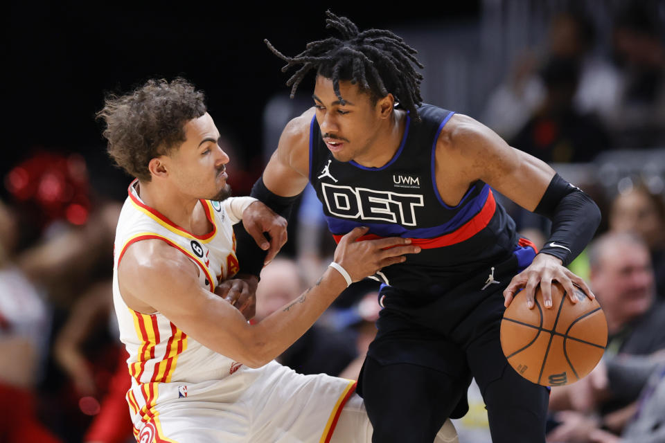 Detroit Pistons guard Jaden Ivey, right, drives against Atlanta Hawks guard Trae Young during the first half of an NBA basketball game Tuesday, March 21, 2023, in Atlanta. (AP Photo/Alex Slitz)