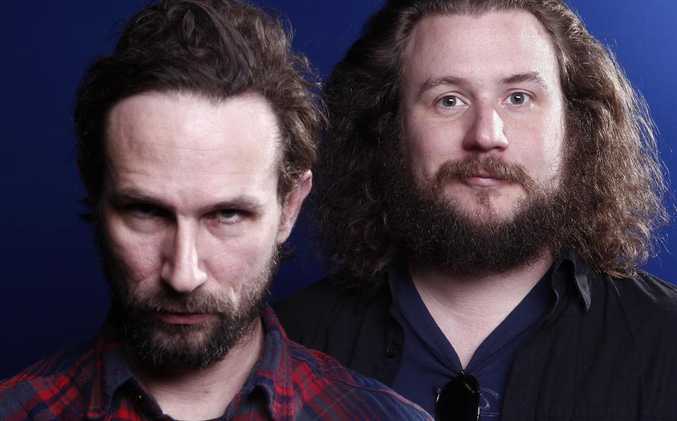 In this March 15, 2012 photo, musicians Will Johnson, left, and Yim Yames of the group "New Multitudes" pose for a portrait in New York. The group, which also includes Jay Farrar and Anders Parker, honors Woody Guthrie with new music based on his unfinished works. (AP Photo/Carlo Allegri)