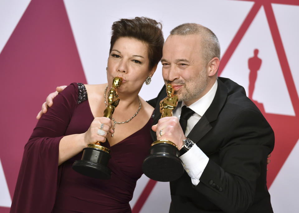 Nina Hartstone, left, and John Warhurst kiss their awards for best sound editing for Bohemian Rhapsody (Jordan Strauss/AP)