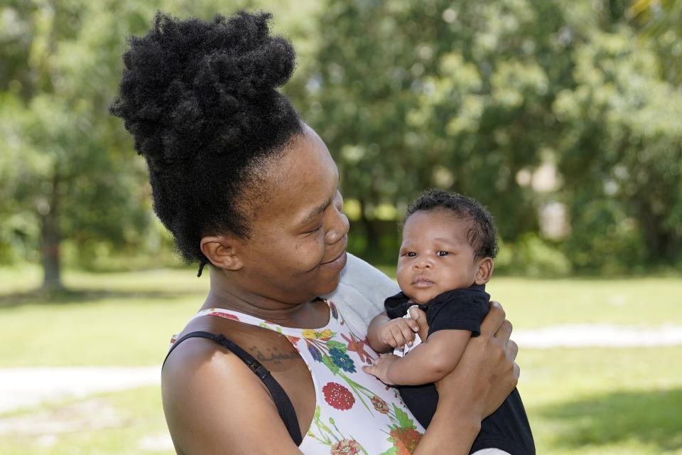 Venessa Aiken holds her son Jahzir Robinson, five weeks old, outside their home Sunday, Aug. 21, 2022, in Orlando, Fla. States around the country are making it easier for newborn moms to keep Medicaid in the year after childbirth, a crucial time when depression and other health problems can develop.(AP Photo/John Raoux)