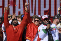 FILE - Kansas City Chiefs quarterback Patrick Mahomes, center, and defensive tackle Derrick Nnadi, left, join in the celebration as defensive tackle Chris Jones, right, announces he plans to return to the Chiefs for another season, during their victory rally in Kansas City, Mo., Wednesday, Feb. 14, 2024. The Chiefs defeated the San Francisco 49ers Sunday in the NFL Super Bowl 58 football game. (AP Photo/Reed Hoffmann, File)
