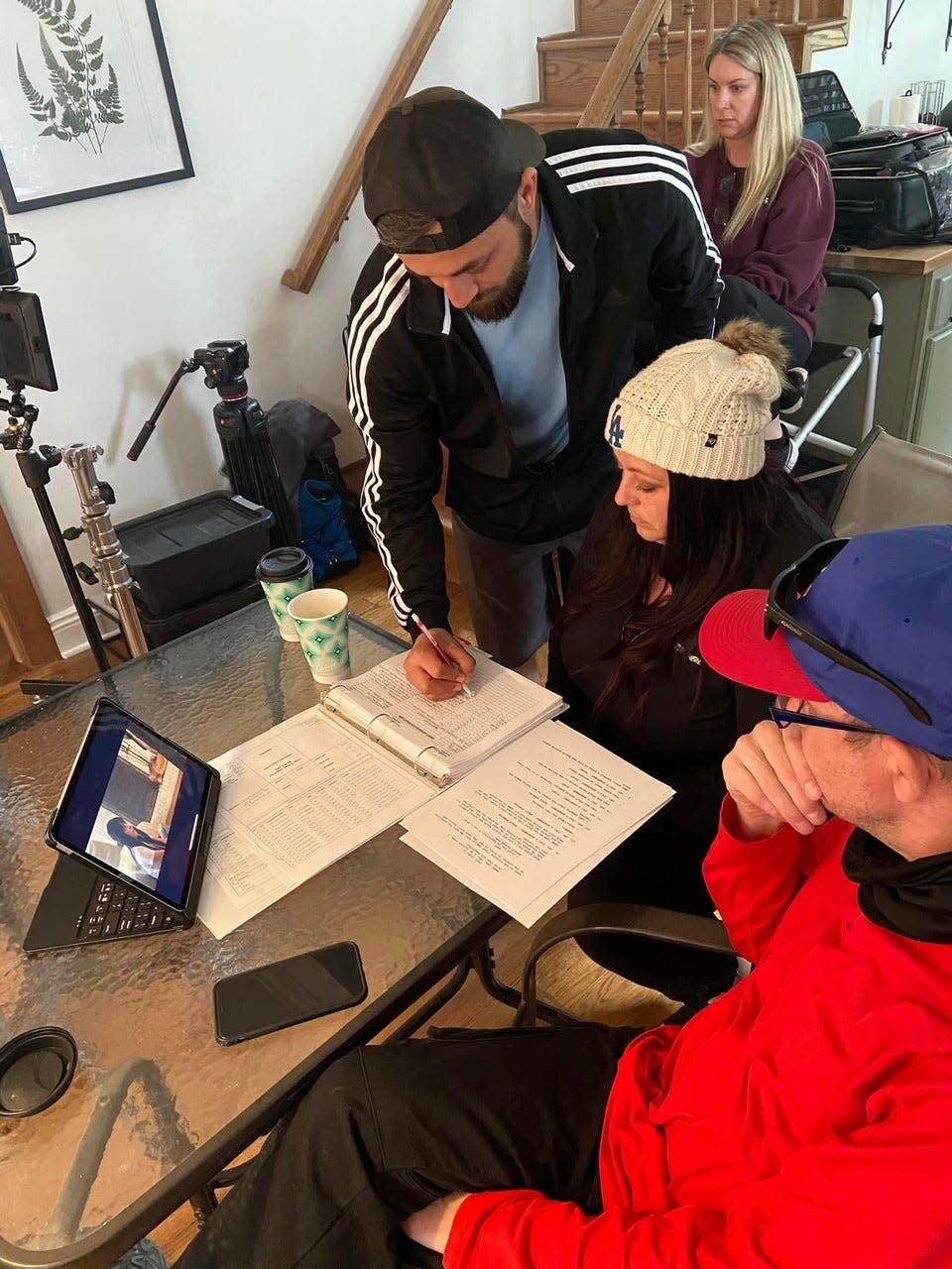 Nicole Ice reviews continuity notes during the production of "Gemini" in April 2023 with her brother Beau Ice, the film's continuity editor and script supervisor, right, and executive producer Jimmy Taaffe. Taaffe also wrote the novel the film is based on.