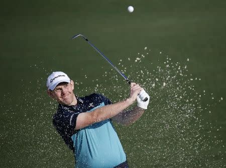 Stephen Gallacher of Scotland hits from a sand trap onto the second green during first round play of the Masters golf tournament at the Augusta National Golf Course in Augusta, Georgia April 9, 2015. REUTERS/Jim Young