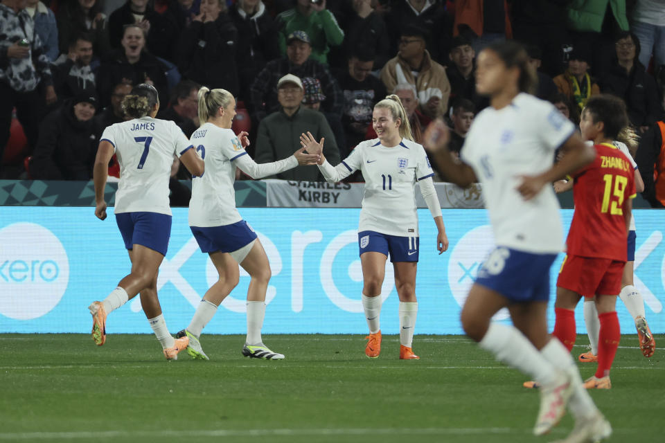 England's Lauren Hemp, centre, celebrates with teammate after scored during the Women's World Cup Group D soccer match between China and England in Adelaide, Australia, Tuesday, Aug. 1, 2023. (AP Photo/James Elsby)