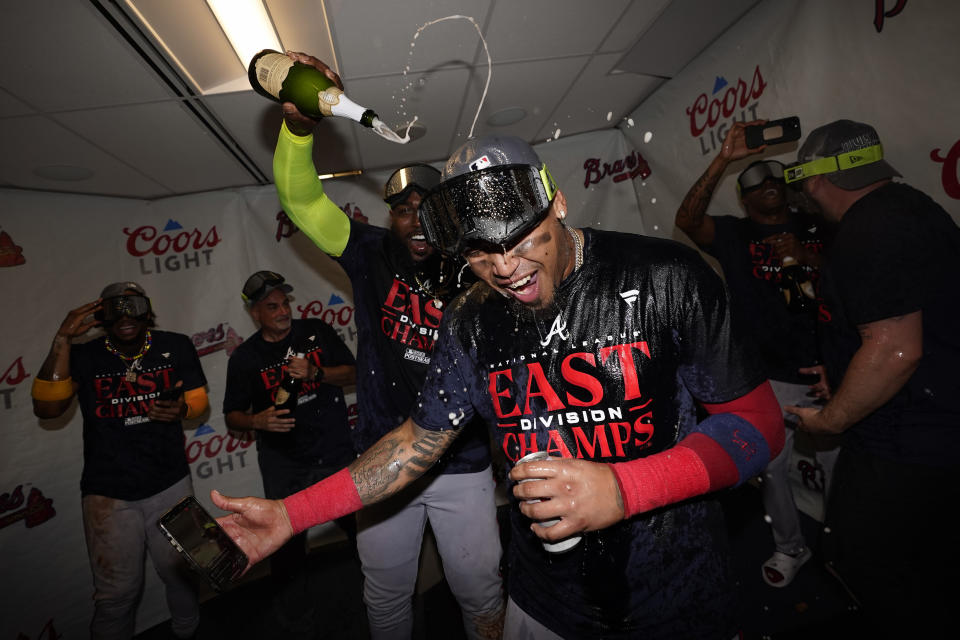 Atlanta Braves' Orlando Arcia celebrates with teammates after the Braves clinched their sixth consecutive NL East title by defeating the Philadelphia Phillies in a baseball game, Wednesday, Sept. 13, 2023, in Philadelphia. (AP Photo/Matt Slocum)