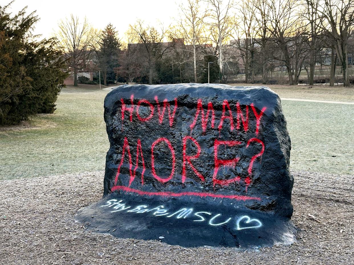 “How Many More?” is painted on the MSU rock the morning after a shooting at Michigan State University on Tuesday, Feb. 14, 2023, on campus in East Lansing.