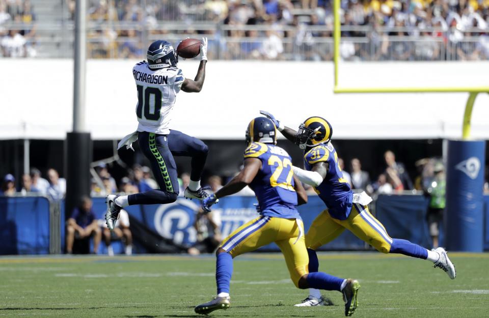 <p>Seattle Seahawks wide receiver Paul Richardson, left, makes a catch while under pressure from Los Angeles Rams cornerback Trumaine Johnson, center, and free safety Maurice Alexander during the first half an NFL football game at the Los Angeles Memorial Coliseum, Sunday, Sept. 18, 2016, in Los Angeles. (AP Photo/Jae Hong) </p>