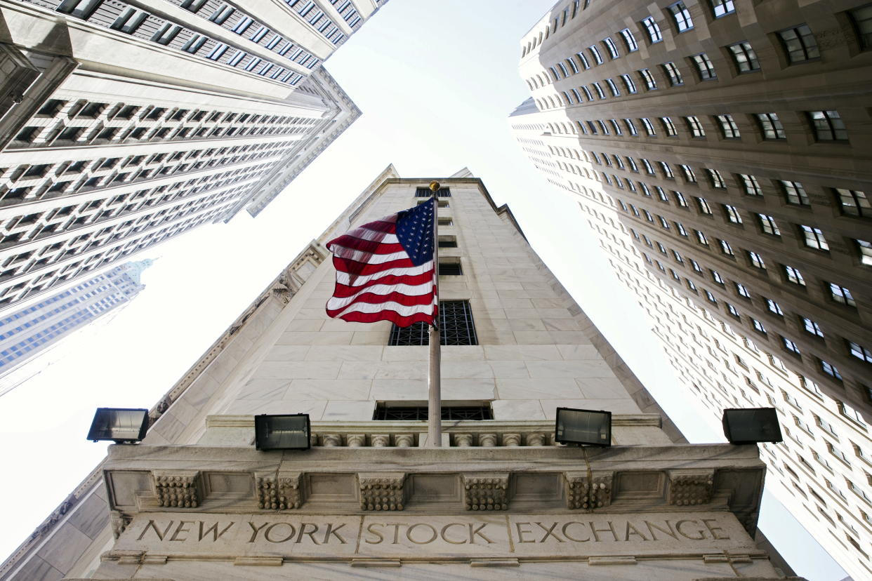 A U.S. flag hangs above an entrance to the New York Stock Exchange August 26, 2015. REUTERS/Lucas Jackson
