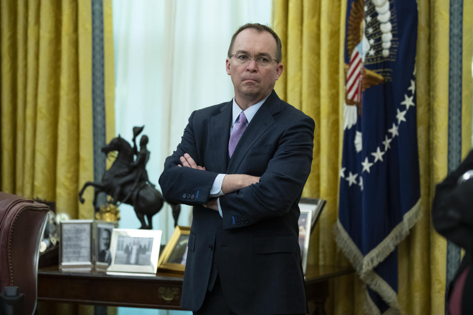 White House chief of staff Mick Mulvaney listens during a meeting between President Donald Trump and Rep. Jeff Van Drew, D-N.J., who is planning to switch his party affiliation, in the Oval Office of the White House, Thursday, Dec. 19, 2019, in Washington. (AP Photo/ Evan Vucci)