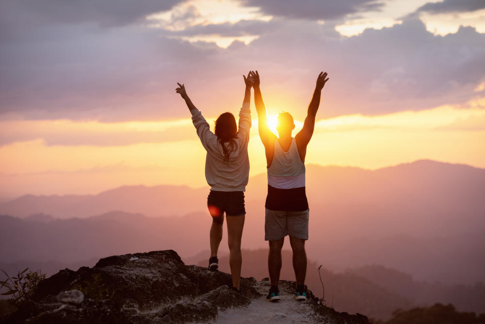 Couple celebrating on mountain peak