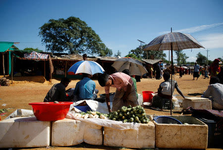 Mohammad Zubair, 14, a Rohingya refugee boy, works on the vegetable stall belonging to his father at Kutupalong refugee camp near Cox's Bazar, Bangladesh, November 12, 2017. REUTERS/Navesh Chitrakar