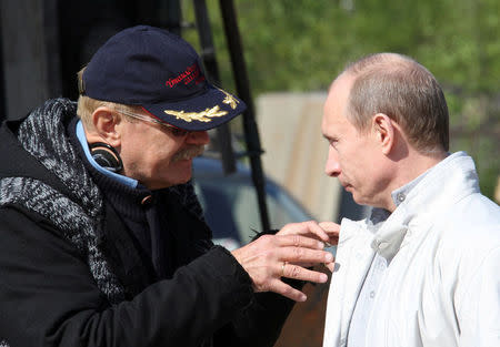 FILE PHOTO: Incoming Russian Prime Minister Vladimir Putin (R) listens to explanations from film director Nikita Mikhalkov at a shooting area of the movie "Burnt by the Sun" Part Two in Shushary settlement outside St.Petersburg May 13, 2008. RIA Novosti/Kremlin/Sergei Subbotin/Pool/File Photo via REUTERS