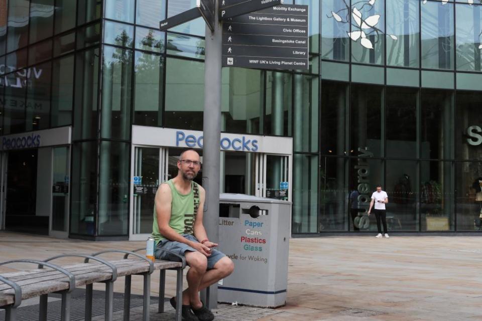 Richard Price sits in Woking town centre