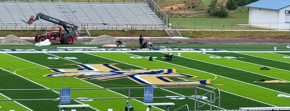 Work continues on the Olympic track that will surround the school's football and soccer field.