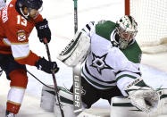 Dallas Stars goaltender Anton Khudobin (35) makes a save as Florida Panthers left wing Vinnie Hinostroza (13) closes in during the second period of an NHL hockey game Wednesday, Feb. 24, 2021, in Sunrise, Fla. (AP Photo/Jim Rassol)