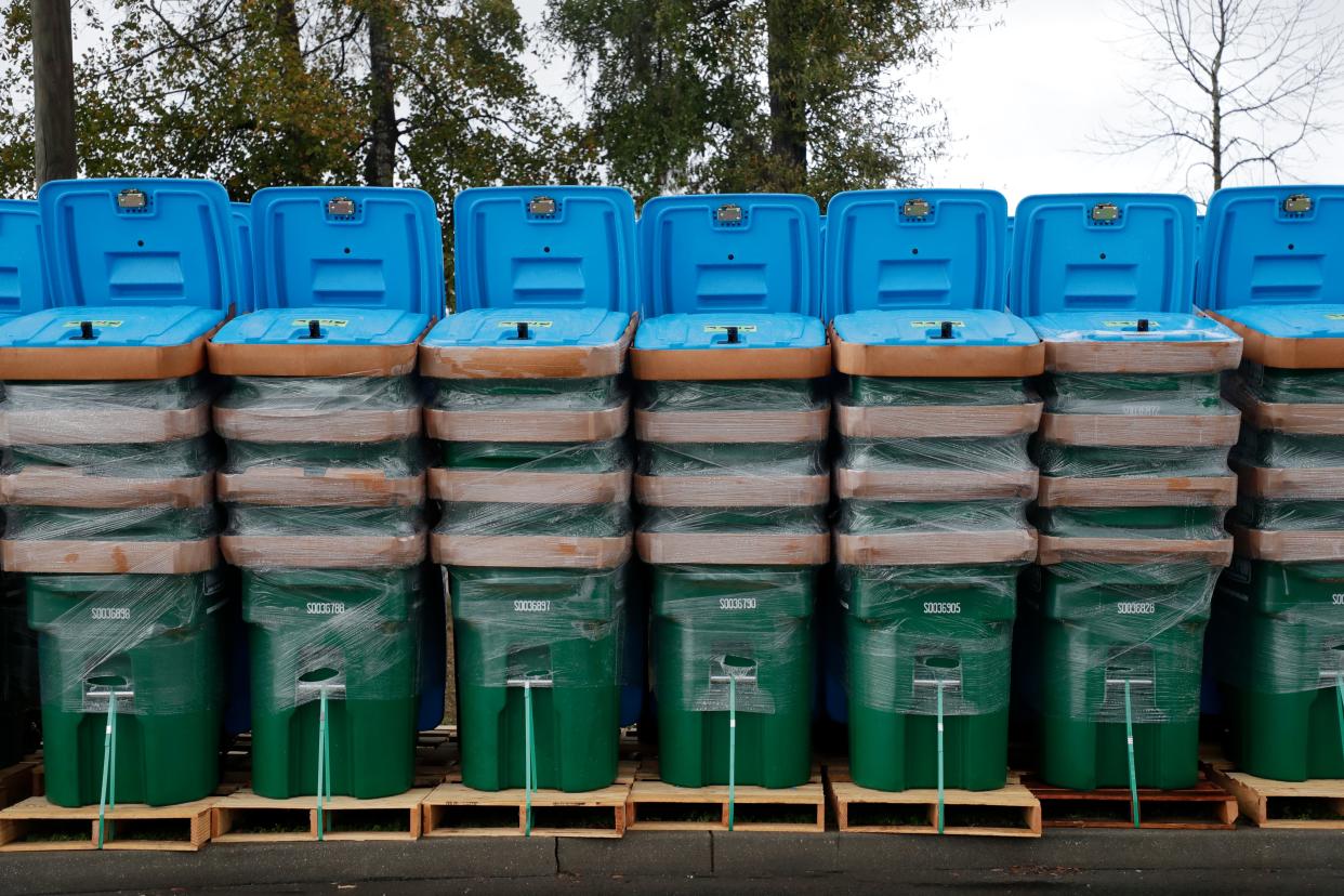 Bear proof garbage cans stacked and lined up, ready to be delivered to Waste Pro customers in Wakulla and Franklin county at their request. A fee will be added to the customer's bill to pay for the locking container.