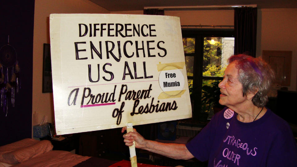 Frances Goldin shows the other side of her sign. (Photo: Courtesy of Frances Goldin.)