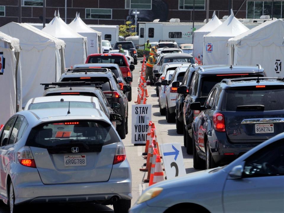 Motorists sit inside their vehicles as they wait their turn to be inoculated with a COVID-19 vaccine at the California State University, Los Angeles campus in Los Angeles, Thursday, April 8, 2021.