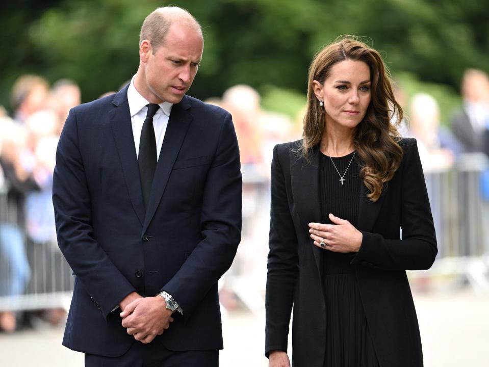 Prince William and Kate Middleton, the Prince and Princess of Wales, walk together.