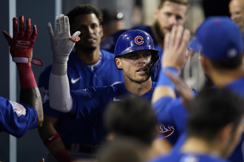 Chicago Cubs' Nico Hoerner, center, returns to the dugout after hitting a home run during the fifth inning of a baseball game against the Los Angeles Dodgers in Los Angeles, Friday, July 8, 2022. (AP Photo/Ashley Landis)