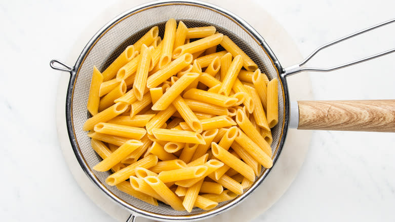 Boiled pasta in strainer