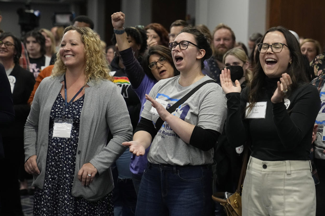 Issue 1 supporters cheer at a watch party.