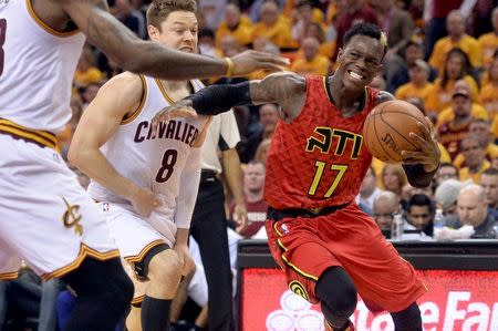 Atlanta Hawks guard Dennis Schroder (17) drives past Cleveland Cavaliers guard Matthew Dellavedova (8) during the second half in game one of the second round of the NBA Playoffs at Quicken Loans Arena. The Cavs won 104-93. Mandatory Credit: Ken Blaze-USA TODAY Sports