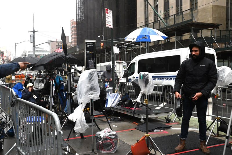 Television media crews covering the trial of former President Donald Trump work in rainy weather outside Manhattan criminal court in New York. Photo by Louis Lanzano/UPI