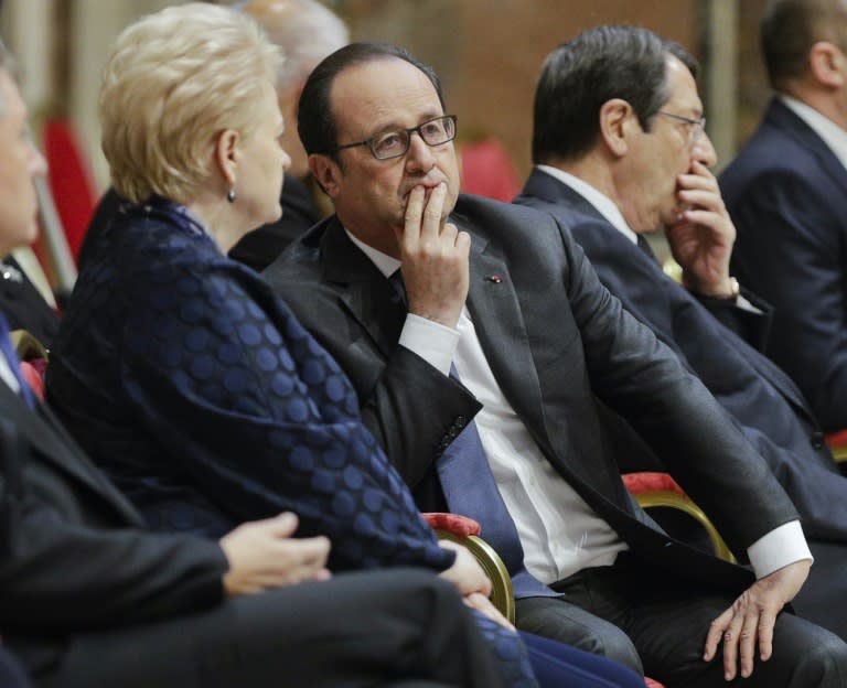 France's President Francois Hollande (C) speaks to Lithuania's President Dalia Grybauskaite, as they wait for Pope Francis before an audience to European Union leaders at the Vatican, on March 24, 2017