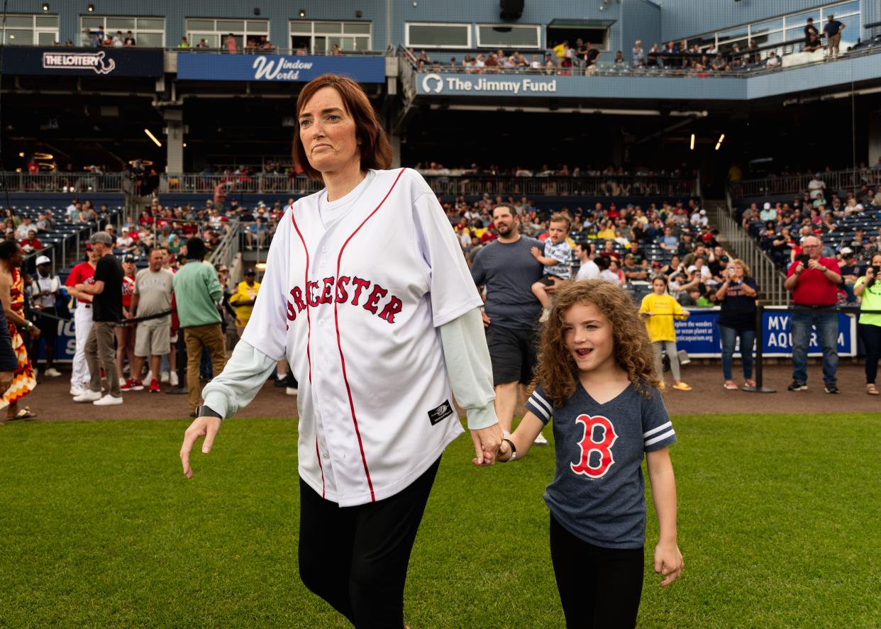 Meghan Milonopoulos, left, and daughter Mia walk out onto the field at Polar Park Saturday before Milonopoulos tossed out a ceremonial first pitch on Saturday, June 24, 2023.
