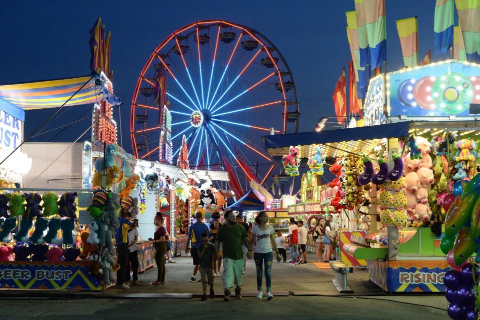 The midway bustles with activity during the opening night at the Brockton Fair on Friday, June 29, 2018.