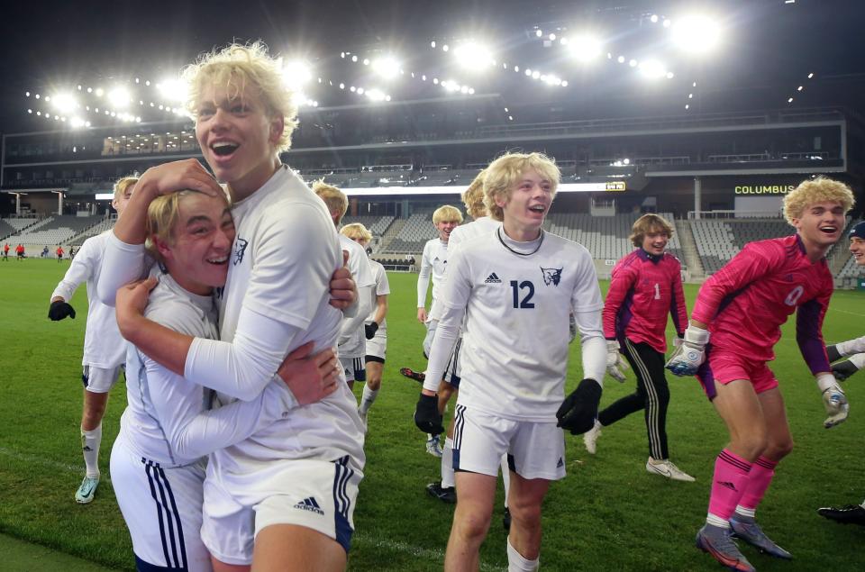 6. Graham Nelson, Blake Yates and Teddy Murphy celebrate Grandview Heights' Division III state championship Nov. 12 at Lower.com Field. Grandview defeated Toledo Ottawa Hills 3-0 for its second consecutive title.