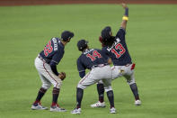 Atlanta Braves right fielder Ronald Acuna (13) takes a fake selfie with left fielder Nick Markakis, left, and center fielder Cristian Pache (14) after their win over the Los Angeles Dodgers in Game 2 Tuesday, Oct. 13, 2020, in the best-of-seven National League Championship Series at Globe Life Field in Arlington, Texas. (Curtis Compton/Atlanta Journal-Constitution via AP)