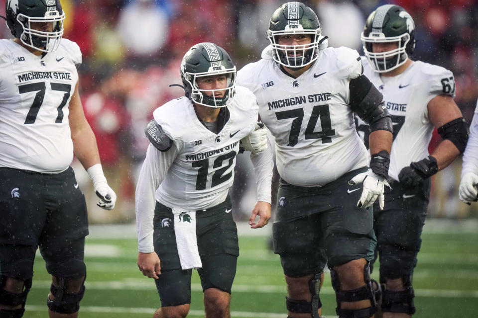 Michigan State quarterback Katin Houser (12) is helped to his feet by Michigan State offensive lineman Geno VanDeMark (74) during the second half of an NCAA college football game against Rutgers Saturday Oct. 14, 2023, in Piscataway, N.J. (AP Photo/Bryan Woolston)