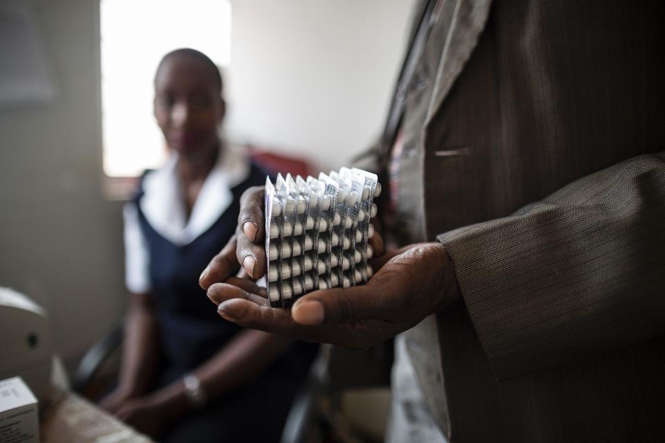 An HIV-positive patient in Malawi holds a month's worth of medication in Nov. 2014. Public health advocates credit the loosening of IP restrictions for expanding access to HIV drugs. (Photo: MARCO LONGARI/Getty Images)