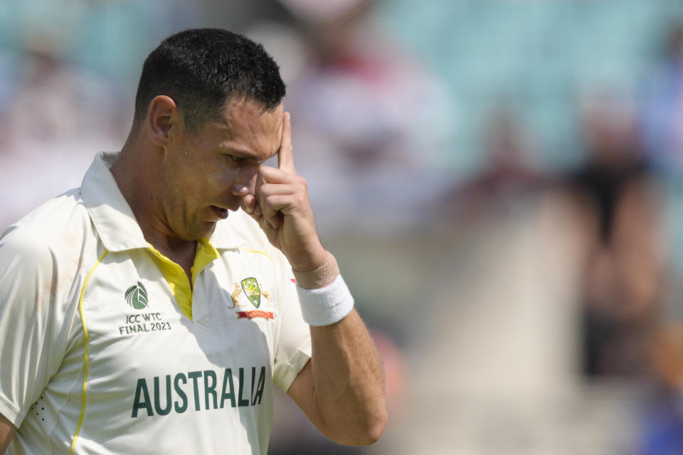 Australia's Scott Boland wipes perspiration from the face as he prepares to bowl on the fifth day of the ICC World Test Championship Final between India and Australia at The Oval cricket ground in London, Sunday, June 11, 2023. (AP Photo/Kirsty Wigglesworth)