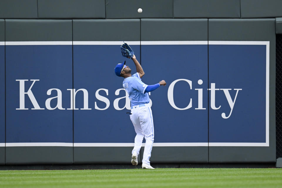 Kansas City Royals center fielder Michael A. Taylor catches this fly off the bat of the Houston Astros' Yordan Alvarez during the first inning of a baseball game, Sunday, June 5, 2022, in Kansas City, Mo. (AP Photo/Reed Hoffmann)