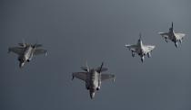 In this Tuesday, May 21, 2019 photo, Qatari Air Force Mirage 2000s, right, and U.S. F-35A Lightning IIs fly in formation over Southwest Asia in undisclosed location. (Senior Airman Keifer Bowes/U.S. Air Force via AP)