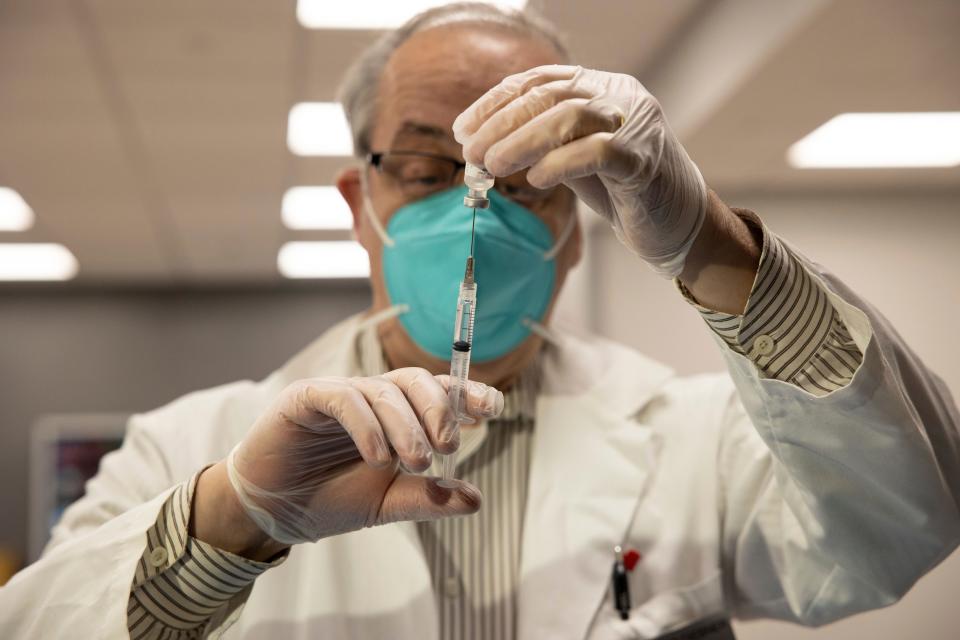 FILE - CVS Pharmacist Gerard Diebner prepares the COVID-19 vaccine for the nursing home residents at Harlem Center for Nursing and Rehabilitation, a nursing home facility, on Jan. 15, 2021, in Harlem neighborhood of New York.