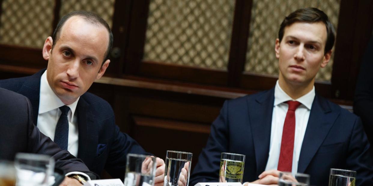 Senior Advisers to President Donald Trump Stephen Miller, left, and Jared Kushner, listen as Trump speaks during a meeting with business leaders in the Roosevelt Room of the White House in Washington, Monday, Jan. 30, 2017.